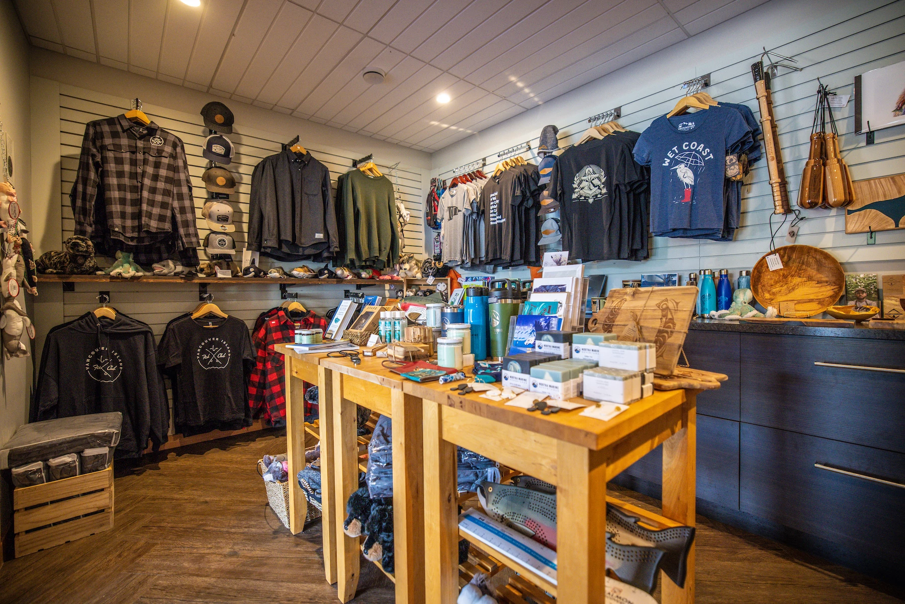 Nootka Sound Resort gift shot with assorted clothing items, hats, and accessories neatly displayed on shelves and racks.